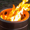 Outdoor fire burning brightly inside a durable steel cooking device with ventilation holes, ideal for Farm, Garden & Tool, Camping, Best Sellers, and Promo Eligible collections.