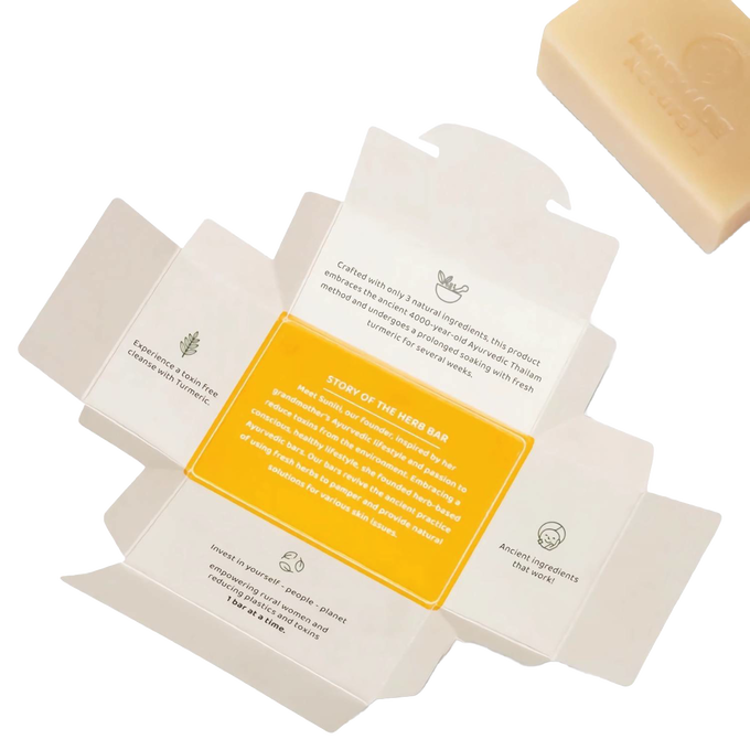 Open packaging of turmeric skin glow Ayurvedic bar soap showing natural ingredients and story of the herb, handmade and organic, featured in Health & Wellness and Soaps collections.