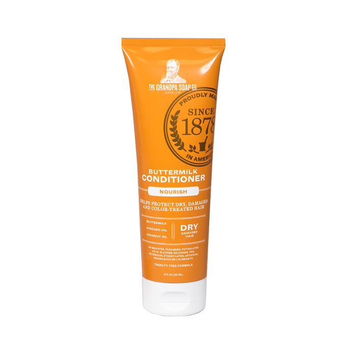 Bright orange tube of buttermilk conditioner labeled for nourishing dry, damaged, and color-treated hair, handcrafted and made in USA, featured in Health & Wellness and Grooming collections.