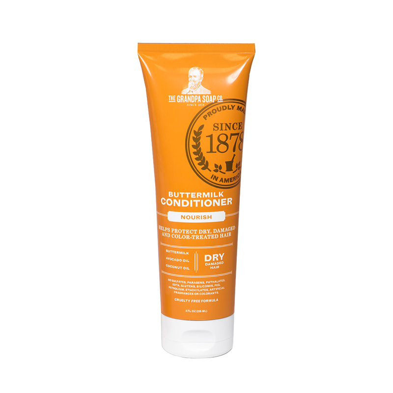 Bright orange tube of buttermilk conditioner labeled for nourishing dry, damaged, and color-treated hair, handcrafted and made in USA, featured in Health & Wellness and Grooming collections.