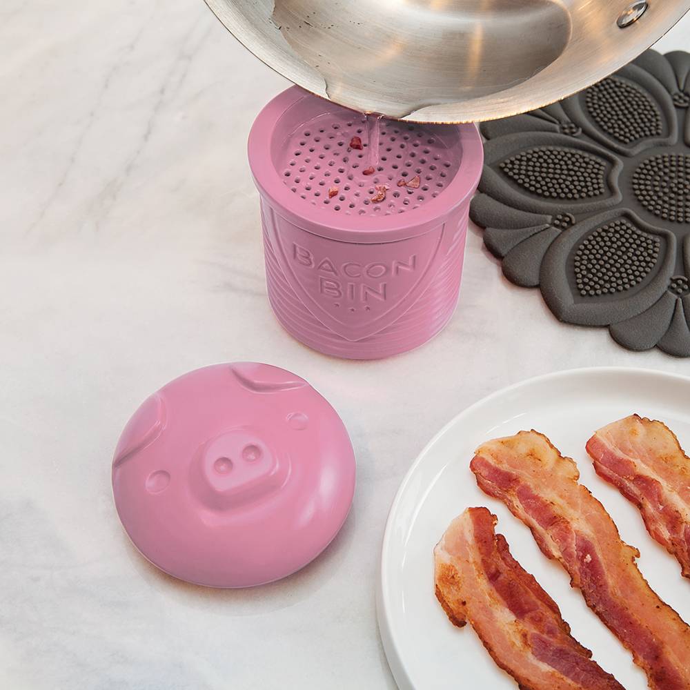 Pink silicone bacon grease holder with strainer lid for easy pouring, shown collecting hot grease from a pan, part of Kitchen & Food, Kitchen Gadgets, and Cooking Helpers collections.