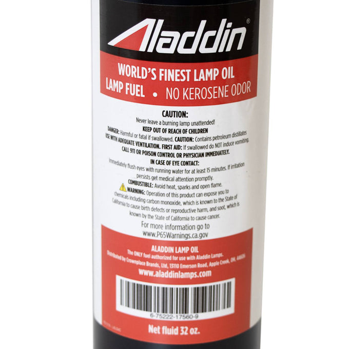 Close-up of a red and white label on a black 32 oz bottle of Aladdin genuine lamp oil emphasizing no kerosene odor and safety warnings, suitable for Lamps & Lighting, Parts and Accessories, Lamp and Lantern Fuel, Best Sellers, and Promo Eligible collections.