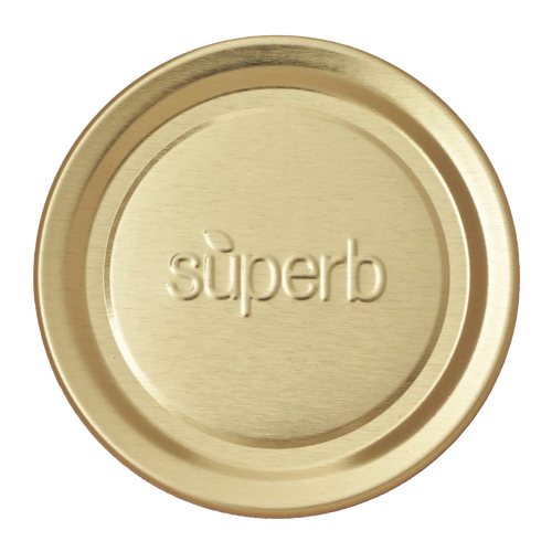 Round metal canning jar lid in a natural brass tone embossed with the word superb, designed for food preservation and kitchen use, part of a USA made collection.