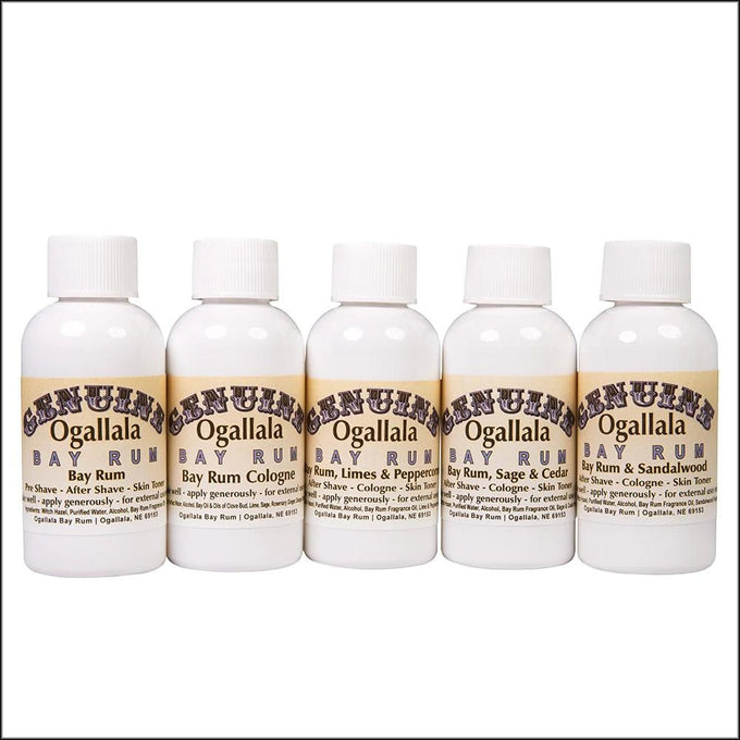 Row of five handcrafted Ogallala Bay Rum cologne and aftershave bottles featuring original, lime and pepper, sage and cedar, and sandalwood scents, made in USA for grooming and personal hygiene collections.