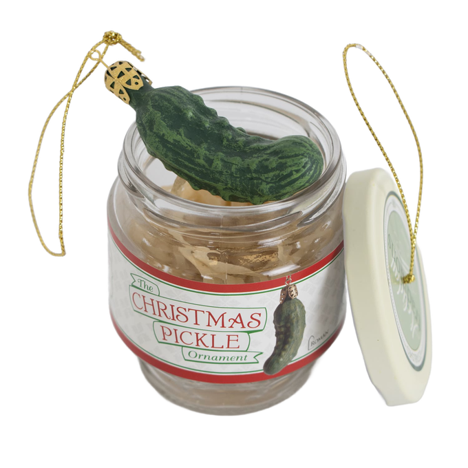 Glass jar ornament set featuring a green pickle decoration with gold hanging strings, designed for festive holiday decor and popular as a unique Christmas tradition gift.