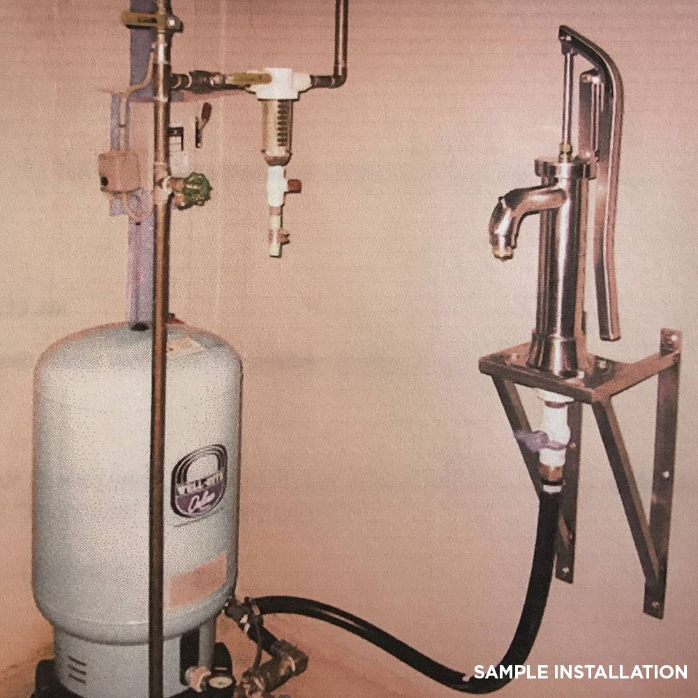 Handcrafted stainless steel shallow well pump with rust-proof pipe and lever handle, wall-mounted next to a pressure tank, featured in Appliances, USA Made, and Water Pumps collections.
