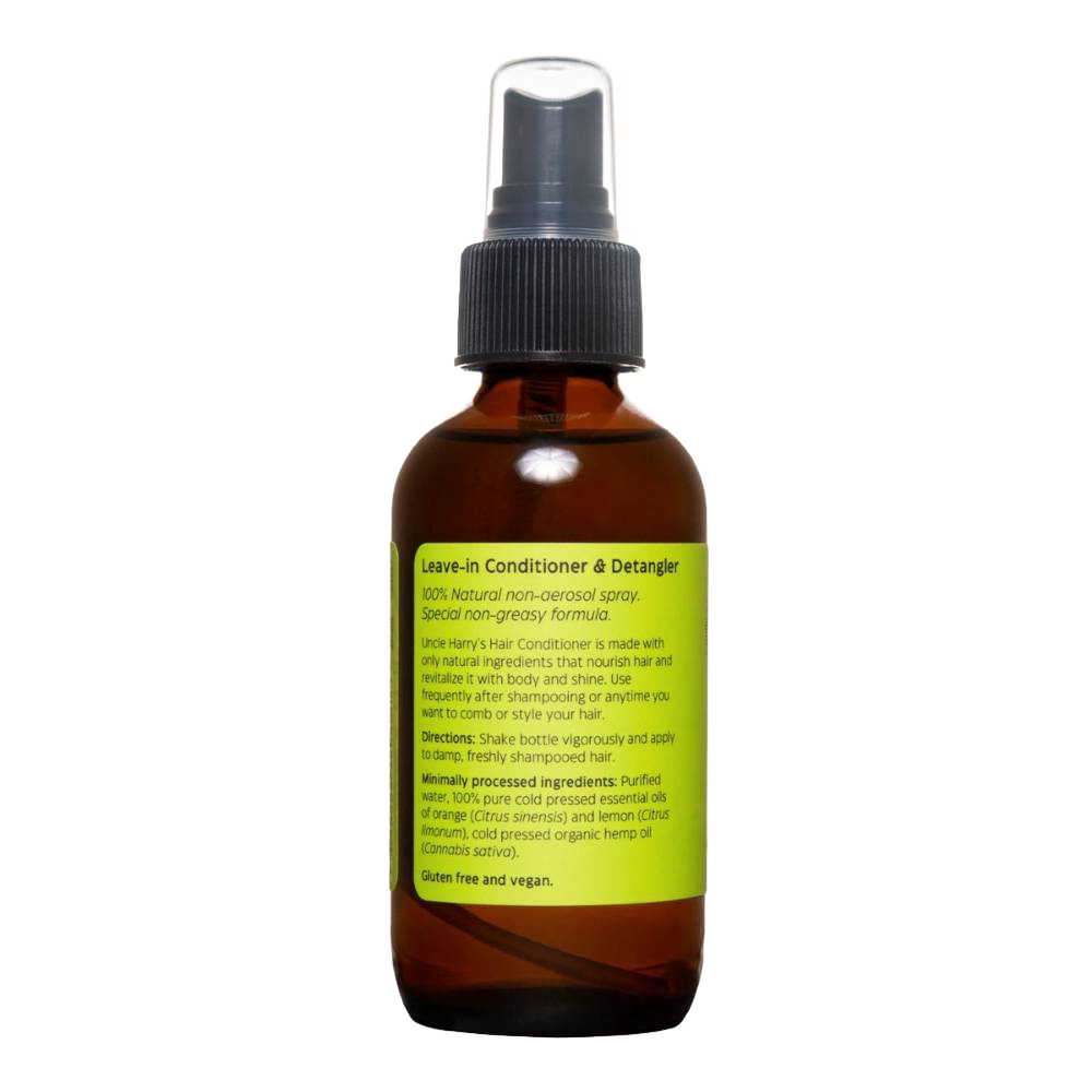 Amber glass spray bottle with a green label detailing natural leave-in conditioner and detangler features, highlighting a citrus scent and vegan formula in Health & Wellness and Grooming collections.