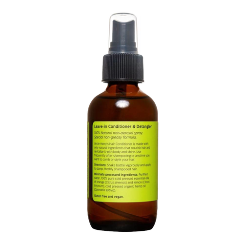 Amber glass spray bottle with a green label detailing natural leave-in conditioner and detangler features, highlighting a citrus scent and vegan formula in Health & Wellness and Grooming collections.