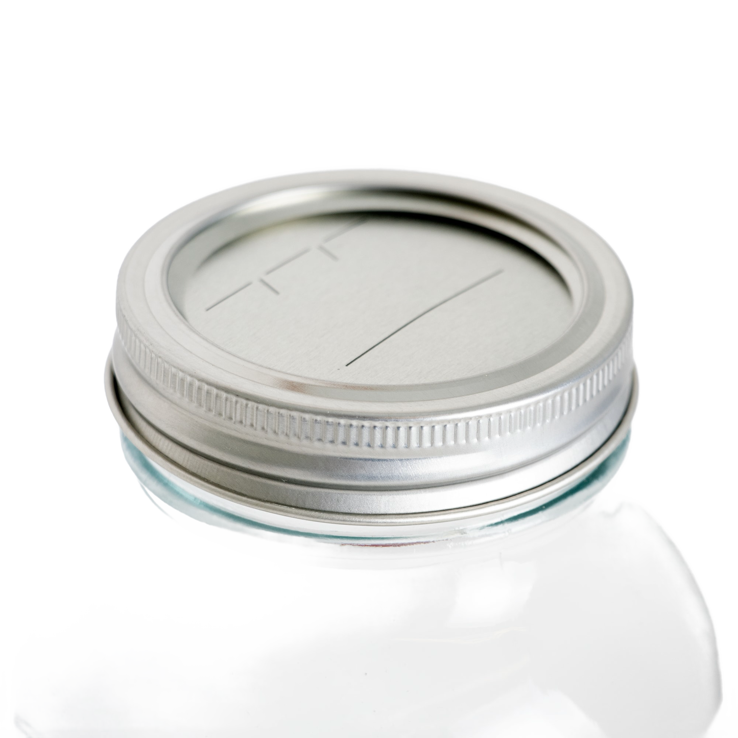 Silver metal regular-mouth canning lid and band set with BPA-free sealing compound on a clear glass jar, ideal for kitchen food preservation in Canning and Kitchen & Food collections.