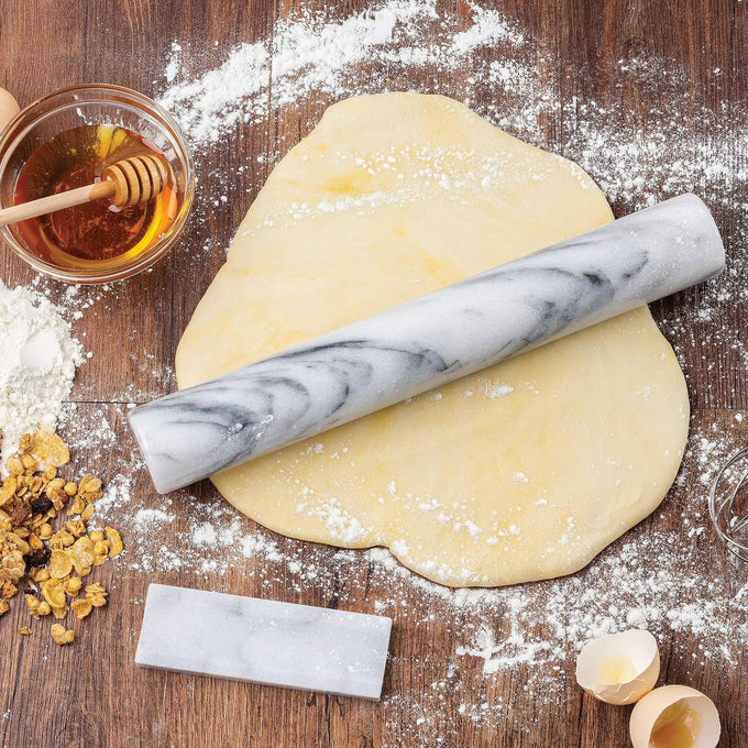 Handle-free marble rolling pin on wooden surface with rolled dough, cracked eggshells, honey, and granola, ideal for Kitchen & Food, Cookware, Baking Supplies, and Best Sellers collections.