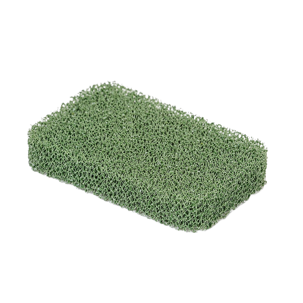 Green silicone cooktop scrubber with a porous texture, designed for durable, odor-resistant cleaning in household and kitchen settings, made in USA.