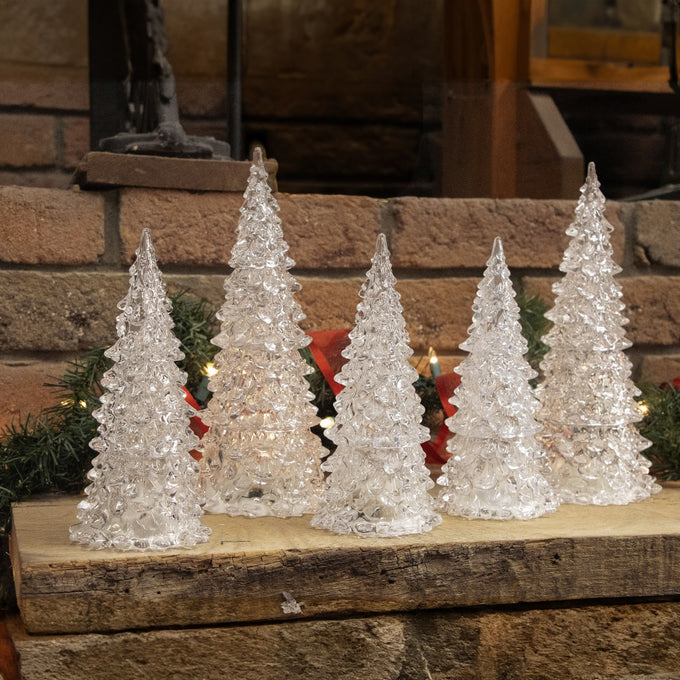 Set of five clear acrylic Christmas trees with textured design, illuminated by subtle multicolored LED lights, ideal for enhancing Home & Decor and Holiday Decor settings.