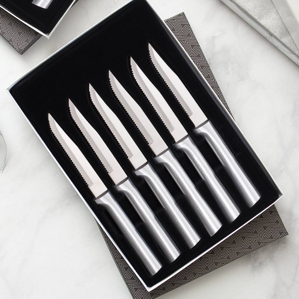 Set of six handcrafted steak knives with smooth stainless steel handles and single-sided serrated blades, made in the USA, ideal for kitchen, food prep, and knife collections.