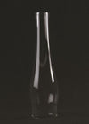 Clear glass oil lamp chimney with a narrow neck and bulged midsection, suitable for lamps and lighting, featured in parts and accessories, chimneys and globes, and best sellers collections.