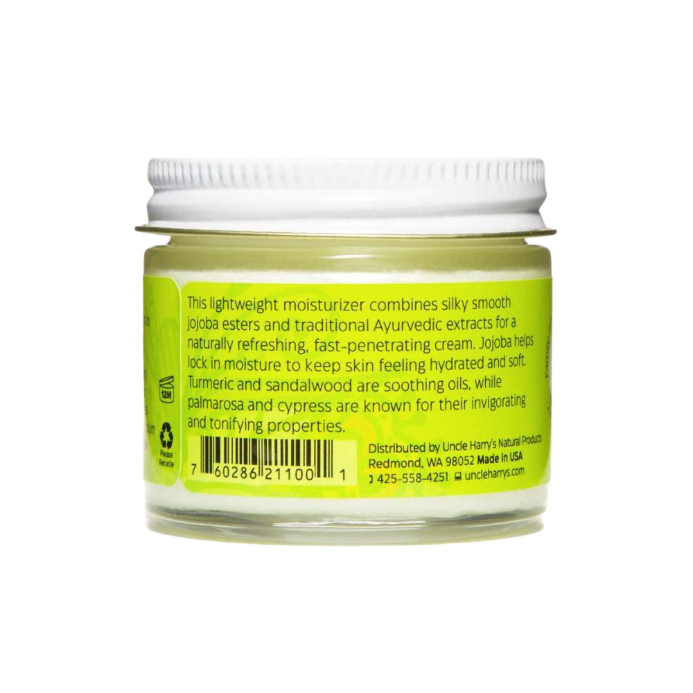 Small glass jar of handcrafted face cream with jojoba esters, turmeric, sandalwood, palmarosa, and cypress extracts, made in USA for health and wellness care.