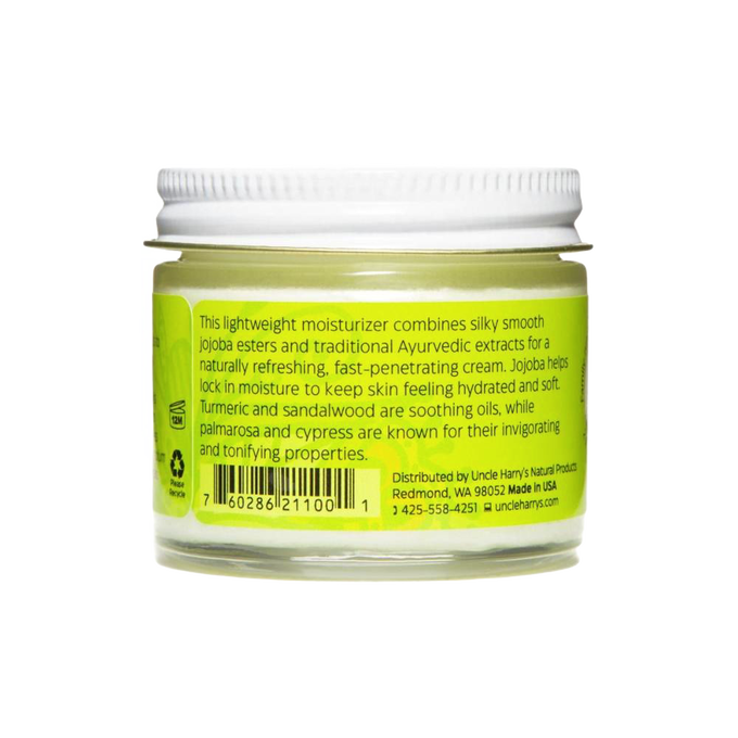 Small glass jar of handcrafted face cream with jojoba esters, turmeric, sandalwood, palmarosa, and cypress extracts, made in USA for health and wellness care.