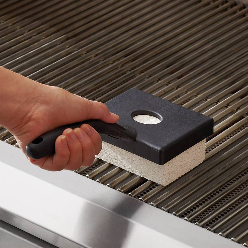 Handheld BBQ stone cleaner with black plastic handle and white pumice surface cleaning stainless steel grill grates, ideal for Kitchen & Food and Kitchen Gadgets collections.