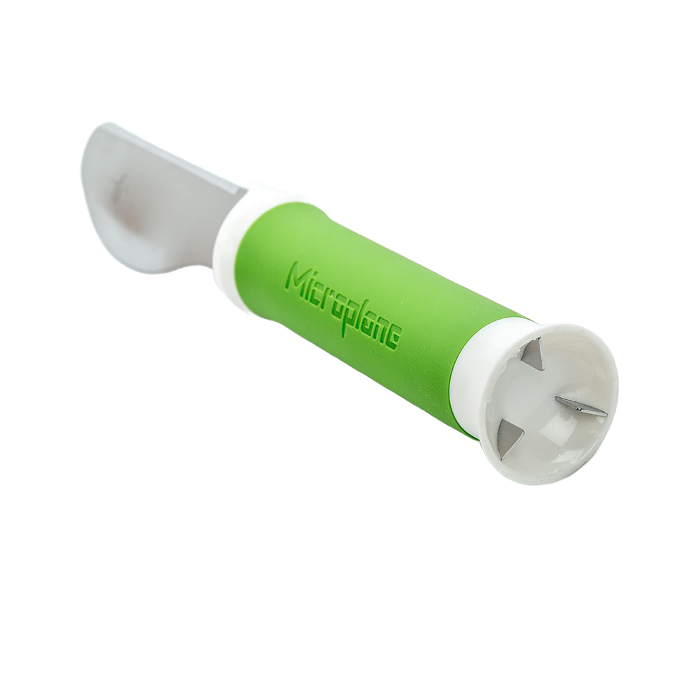 Green-handled 3-in-1 avocado tool with a straight blade for cutting and metal prongs for pitting, designed for efficient food prep in kitchen and garden tool collections.