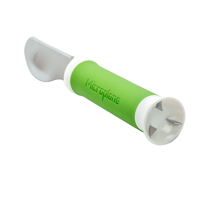 Green-handled 3-in-1 avocado tool with a straight blade for cutting and metal prongs for pitting, designed for efficient food prep in kitchen and garden tool collections.