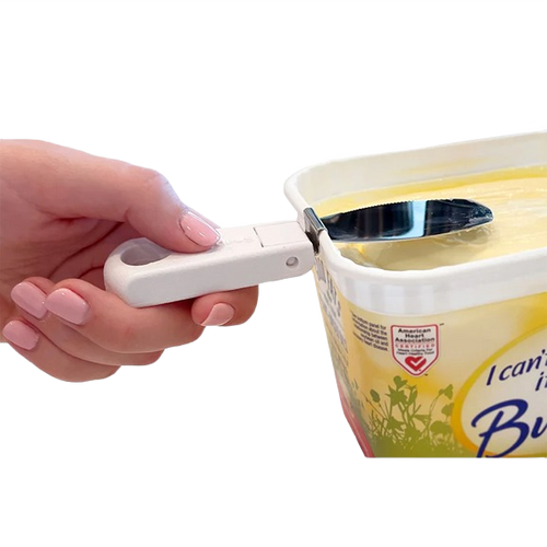 Handheld foldable white butter knife with collapsible handle snapped onto a rectangular butter tub, designed for convenient spreading in Kitchen & Food, Kitchen Gadgets, and Best Sellers collections.