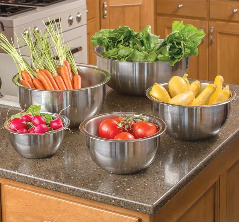 Set of sturdy stainless steel mixing bowls with weighted flat bottoms and wide lips, filled with fresh vegetables, ideal for Kitchen & Food, Cookware, Baking Supplies, and Holiday Hosting collections.