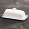 Classic white porcelain butter dish with knob, sturdy two-piece design, ideal for Kitchen & Food, Specialty Equipment, Making Butter, Storage and Serving, Best Sellers, and Promo Eligible collections.