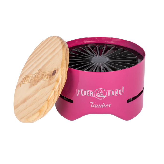 Compact bright pink tabletop charcoal grill with a removable wooden lid engraved with logo, featuring a radial grate design, perfect for small outdoor cooking in Farm, Garden & Tool and Grilling collections.