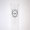 Clear borosilicate glass chimney with black printed logo, designed for enhanced light output in lamps, featured in Lamps & Lighting and Chimneys and Globes collections.