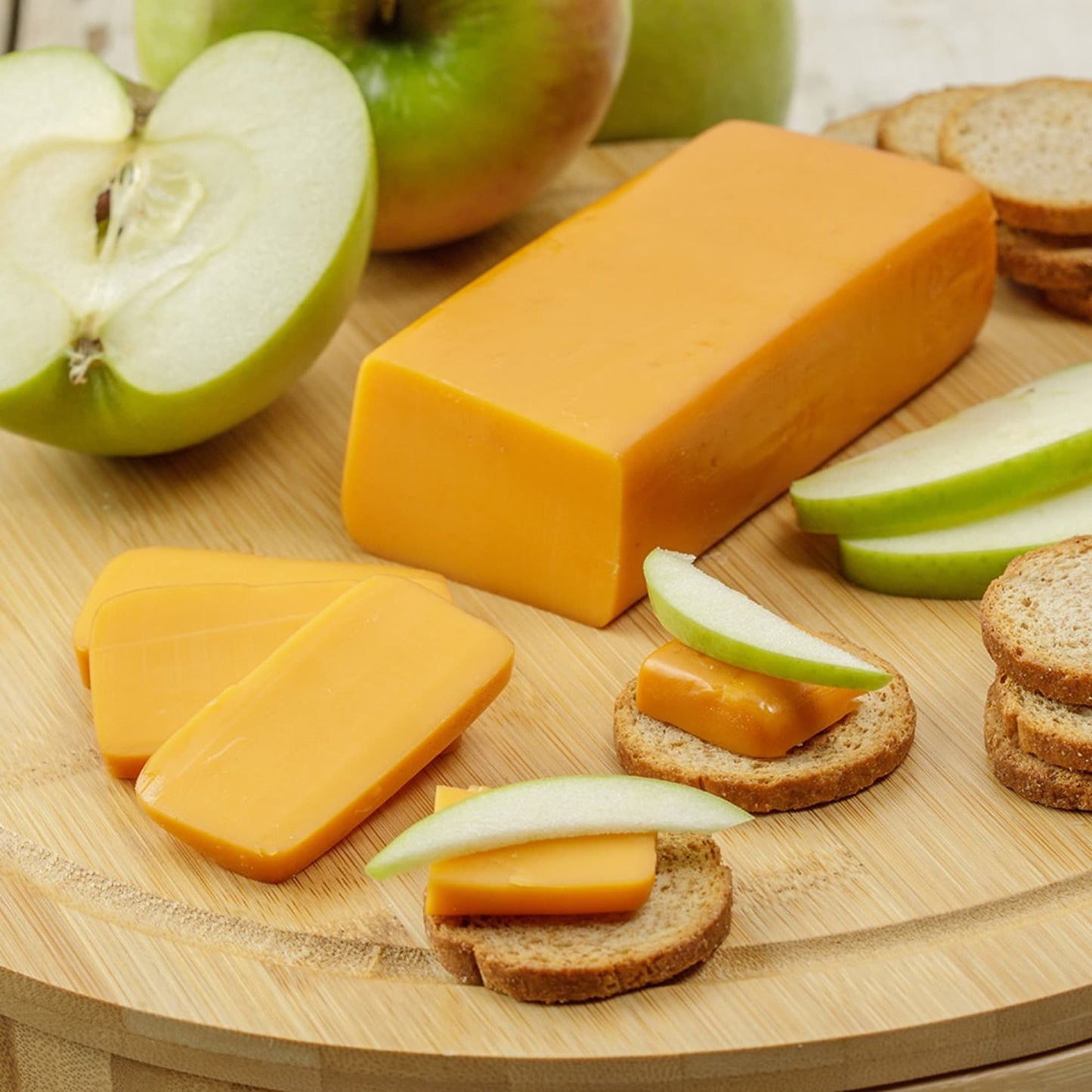 Handcrafted shelf-stable cheese block paired with sliced green apple and crackers on a wooden board, ideal for Kitchen & Food, Snacks and Sweets, Pantry, USA Made, Best Sellers, Promo Eligible collections.