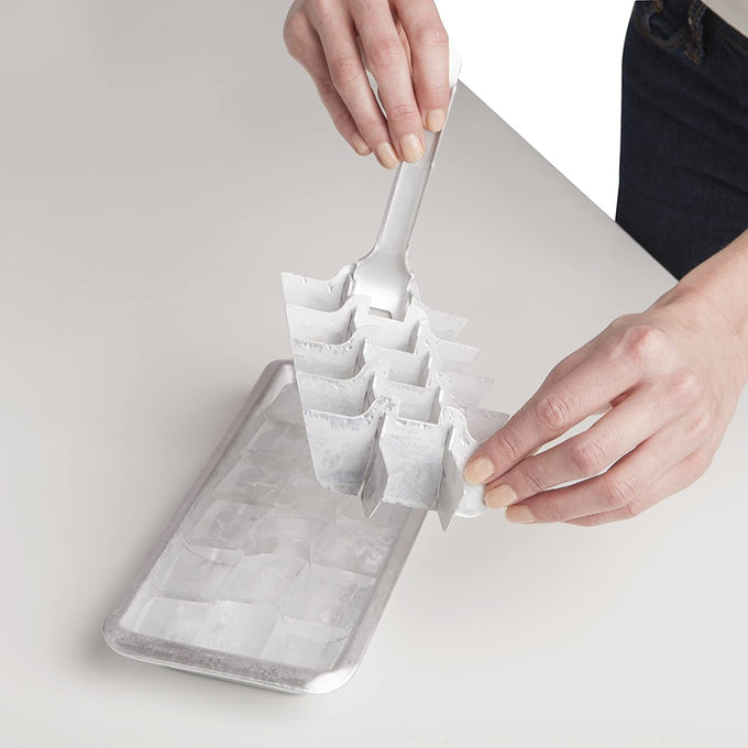 Hand lifting a vintage-style aluminum ice cube tray with an easy-release handle, making ice cube removal simple and efficient for Farm, Garden & Tool, Kitchen & Food, Kitchen Gadgets, Kitchen Accessories, Best Sellers, Homesteading, and Promo Eligible collections.