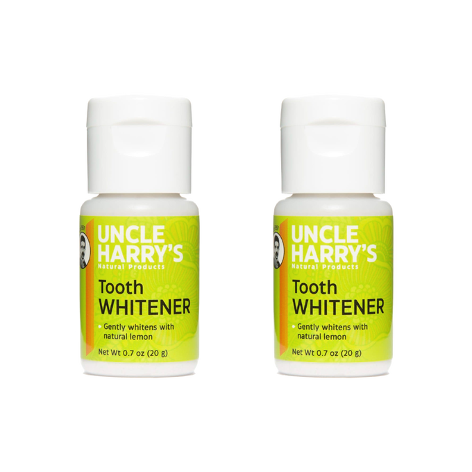 Two small bottles of handcrafted all-natural tooth whitener powder with bright green labels, featuring lemon as a key ingredient, ideal for health, grooming, and USA made collections.
