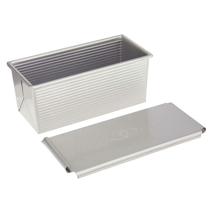 Heavy-duty aluminized steel loaf pan with matching lid, handcrafted for even heat conduction and consistent baking results; ideal for Kitchen & Food, Baking Supplies, and Cookware collections.