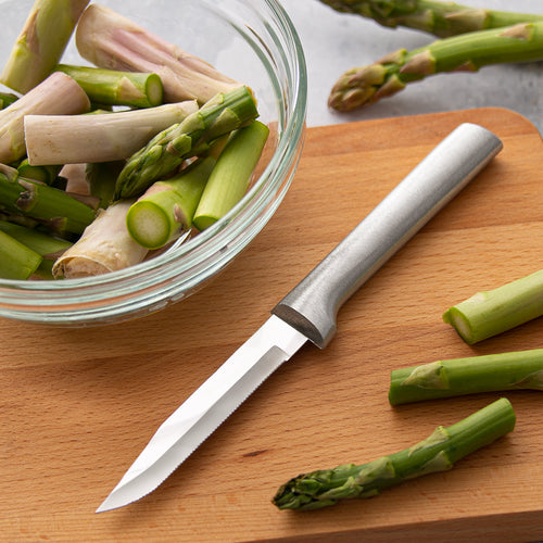 Handcrafted serrated paring knife with a super-fine stainless steel blade and solid metal handle, made in USA, shown on a wooden board with fresh asparagus, ideal for Kitchen & Food and Farm, Garden & Tool collections.