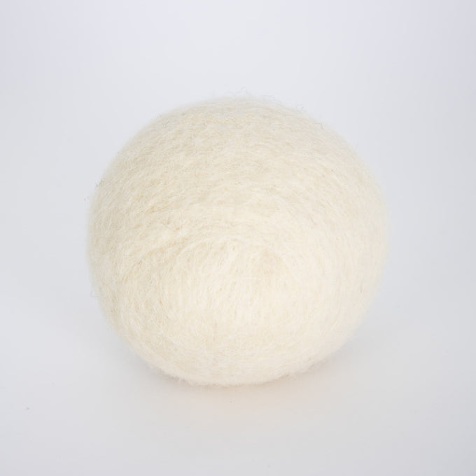 Single natural cream-colored wool dryer ball, handcrafted in the USA for repeated use, featured in Home & Decor and Laundry Supplies collections.