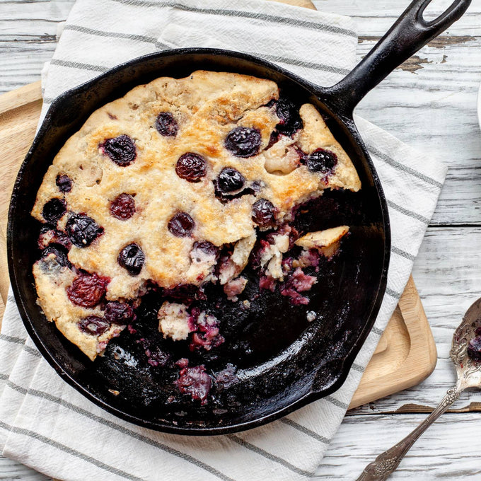 Handcrafted mixed berry cobbler baked in a 6-inch cast iron skillet, styled on a rustic cloth with vintage spoons, perfect for Kitchen & Food, Dry Goods and Mixes, Best Sellers collections.