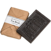 Handcrafted black tea brick with intricate embossed design, wrapped in rustic brown paper packaging, ideal for Kitchen & Food, Brewing Coffee and Tea, Beverages, and Best Sellers collections.
