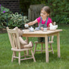 Child playing at a handcrafted, Amish-made wooden table and chair set with a tea party setup including a teddy bear and ceramic tea set, part of Toys, Books & Games and USA Made collections.
