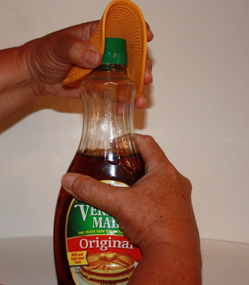 Hands using a textured rubber grip to easily twist open a syrup bottle cap, showcasing a practical kitchen tool included in Kitchen Gadgets, Kitchen Accessories, and USA Made collections.