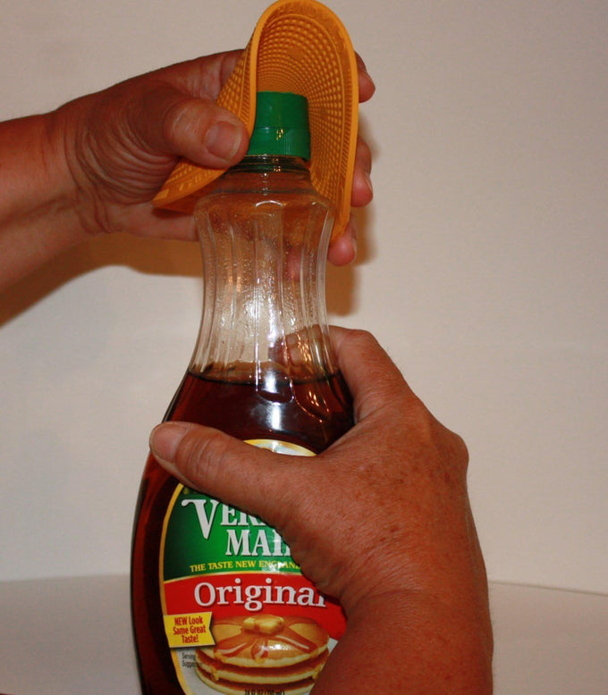 Hands using a textured rubber grip to easily twist open a syrup bottle cap, showcasing a practical kitchen tool included in Kitchen Gadgets, Kitchen Accessories, and USA Made collections.