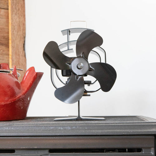 Handcrafted black heat-powered oscillating stove fan with four wide blades and protective guard, designed to circulate warm air efficiently in stoves and hearth accessories collections.