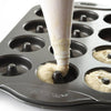 Non-stick baking pan with 12 cavities for making mini donuts, shown being filled with batter from a pastry bag, suitable for kitchen gadgets and baking supplies collections.