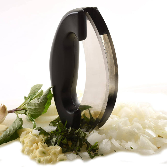 Heavy-duty mezzaluna chopper with ergonomic black handle and dual stainless steel blades, surrounded by chopped garlic, onions, and fresh herbs, featured in Kitchen & Food and Food Prep collections.