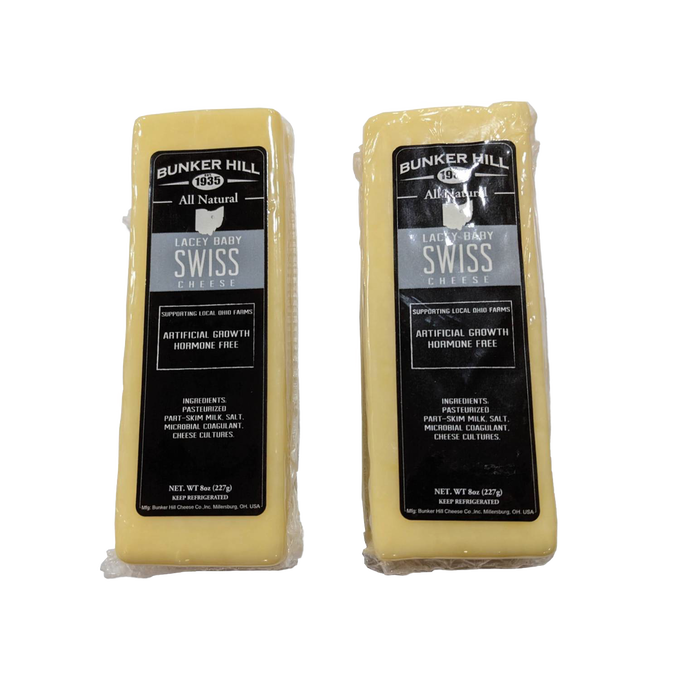Two blocks of handcrafted all-natural Lacey Baby Swiss cheese with black and silver labels, made in the USA, perfect for Kitchen & Food, Food, Meats, and Best Sellers collections.