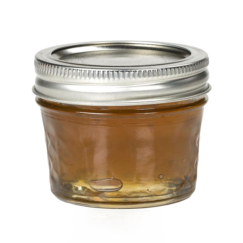 Small clear glass jar with quilted texture and silver metal lid, filled with golden jam, ideal for kitchen, food preservation, and canning uses, handcrafted in USA.