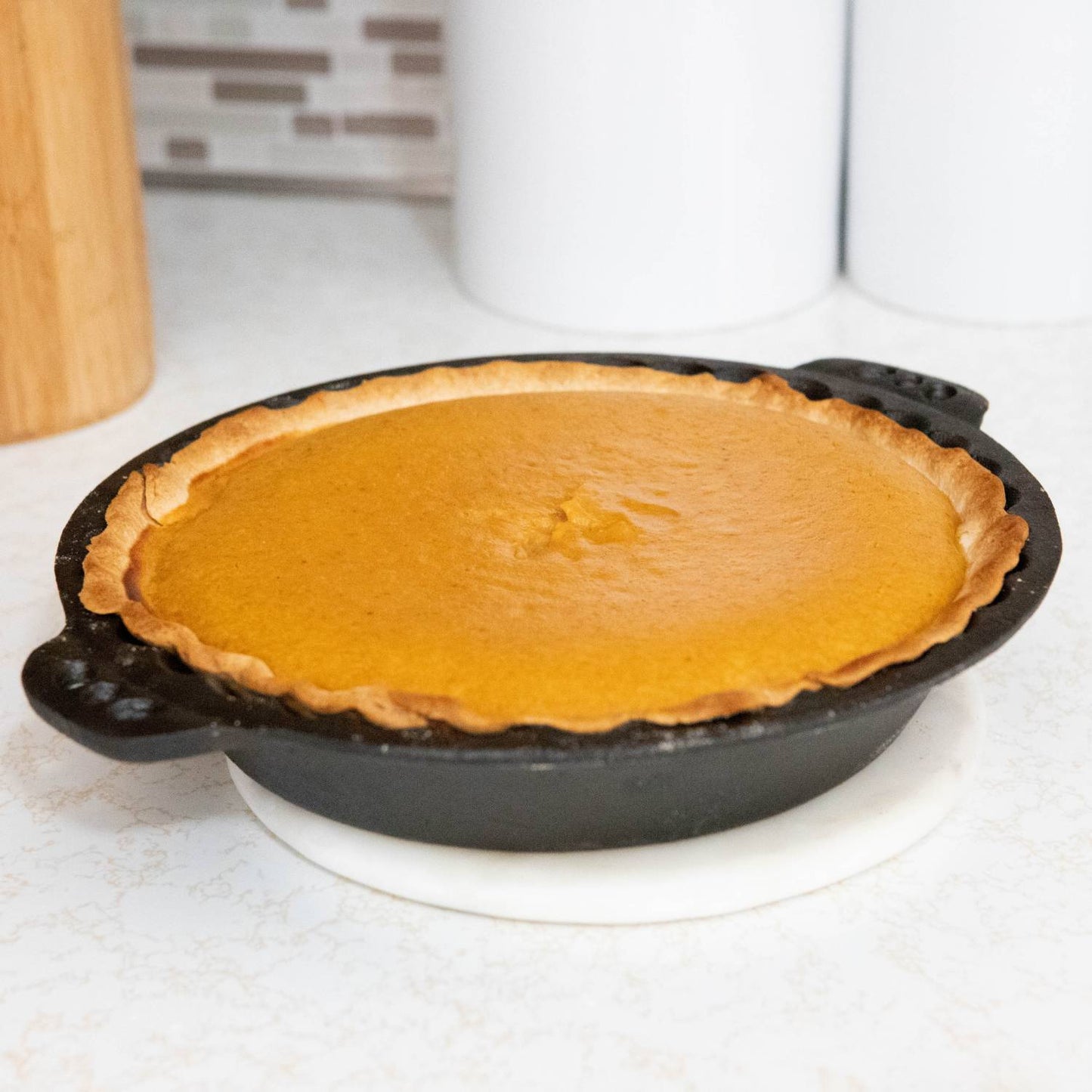 Handcrafted Amish-made cast iron pie pan with crimped edges holding a freshly baked pumpkin pie, ideal for Kitchen & Food, Cookware, Cast Iron, Baking Supplies, Best Sellers, and Promo Eligible collections.
