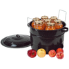Black speckled enamelware canner filled with sealed glass jars of preserved fruit, with a matching lid set aside and fresh apples and peaches nearby, ideal for food preservation and canning.