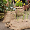 Set of three handcrafted burlap bags made from natural fibers, used as durable plant containers and garden accessories, featured in Farm, Garden & Tool and Best Sellers collections.