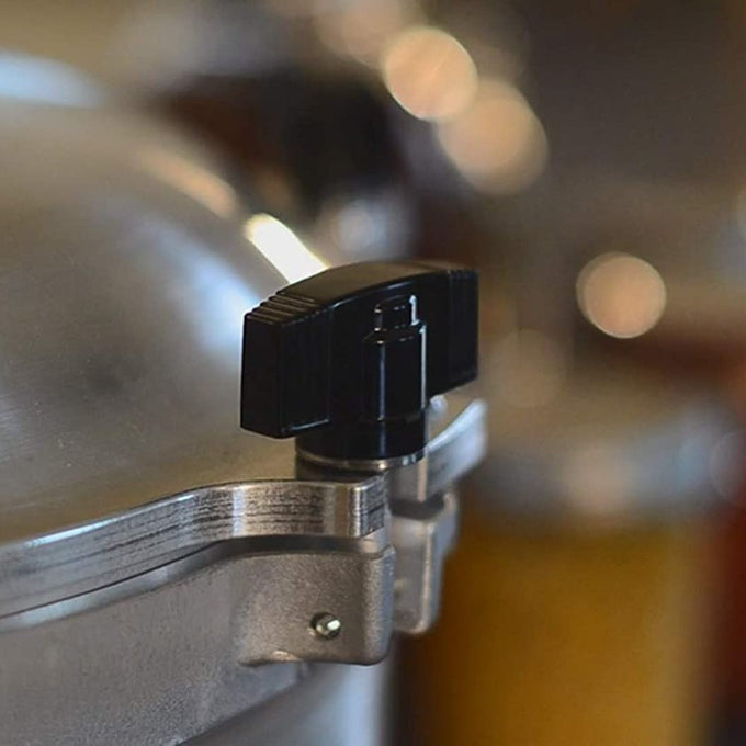 Close-up of a black handle securing the lid of a handcrafted aluminum pressure canner, designed for safe food preservation, featured in Kitchen & Food and Food Preservation collections.