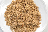 Close-up of handcrafted wholesome granola clusters and whole grain oats on a white plate, showcasing a natural, preservative-free snack from USA-made Amish products in Kitchen & Food collections.
