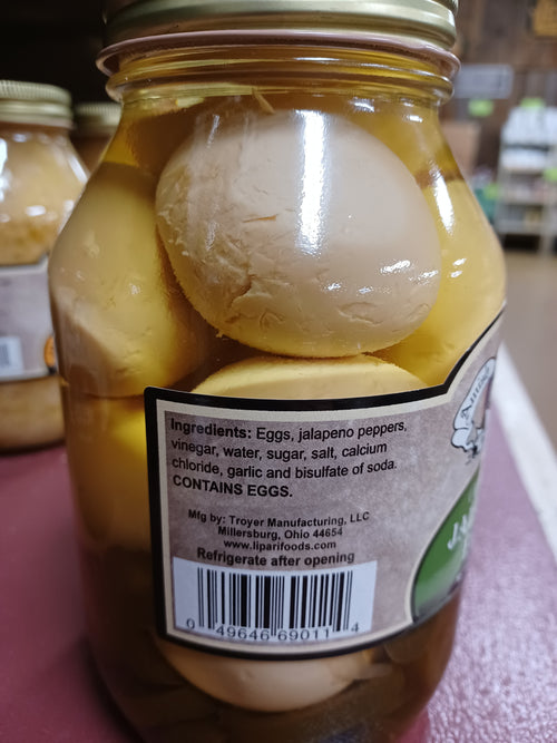 Glass jar of handcrafted canned eggs preserved in yellowish jalapeno pepper brine with vintage-style label and gold metal lid, made in USA, ideal for Kitchen & Food, Pantry, USA Made, Best Sellers, and Promo Eligible collections.